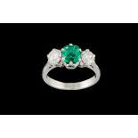 AN EMERALD AND DIAMOND THREE STONE RING, one cushion cut emerald of 0.75ct with gem report, and