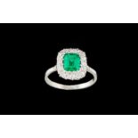 AN EMERALD AND DIAMOND CLUSTER RING, one step cut emerald of 1.09ct with gem report and diamonds