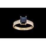 A SAPPHIRE RING, with diamond set band, mounted in 18ct yellow gold