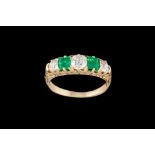 AN EARLY 20TH CENTURY EMERALD AND DIAMOND CARVED DRESS RING, with emeralds of approx 0.50ct and