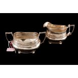 A GEORGE V SILVER SUGAR BOWL AND JUG, reeded collar over four bun feet, Sheffield 1917