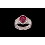 A RUBY AND DIAMOND RING, with ruby of approx. 2.50ct, flanked by six baguette cut diamonds,