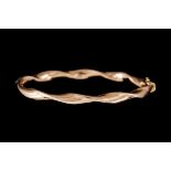 AN 18CT GOLD WAVE BANGLE