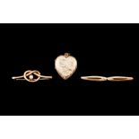 TWO ANTIQUE BROOCHES; together with a heart shaped locket