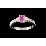 A PINK SAPPHIRE AND DIAMOND THREE STONE RING, mounted in platinum