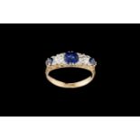 AN EDWARDIAN SAPPHIRE AND DIAMOND CARVED DRESS RING, with sapphires of approx 1.50ct and diamonds of