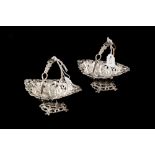 A PAIR OF VICTORIAN SILVER EMBOSSED SWING HANDLED BON BON DISHES, Birmingham 1897