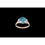 A BLUE ZIRCON AND DIAMOND RING, with one round cut blue zircon of approx 3.