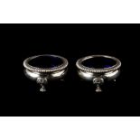 A PAIR OF SILVER PRE-WAR SALTS, London 1939, with blue glass liners,