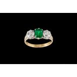 AN EMERALD AND DIAMOND THREE STONE RING, with one cushion cut emerald of approx 1.