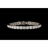 A DIAMOND LINE BRACELET, with diamonds of approx 10.95ct in total, mounted in 18ct white gold.