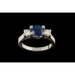A SAPPHIRE AND DIAMOND THREE STONE RING, with oval cut sapphire of approx. 1.