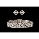 AN ART DECO DIAMOND PANEL BRACELET WITH MATCHING EARRINGS, mounted in platinum.