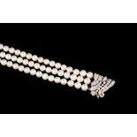 A TRIPLE ROW CULTURED PEARL BRACELET,