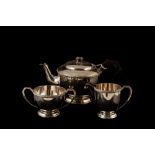 A PRE-WAR THREE PIECE SILVER TEA SERVICE, of plain form, with applied Celtic decoration,