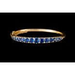 A VICTORIAN SAPPHIRE AND DIAMOND BANGLE, with sapphires of approx 6.00ct in total, in 15ct gold.