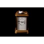 AN EARLY 20TH CENTURY BRASS CARRIAGE CLOCK, white dial with Roman numerals,