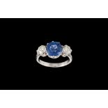 A SAPPHIRE AND DIAMOND THREE STONE RING, with one cushion cut sapphire of approx 3.