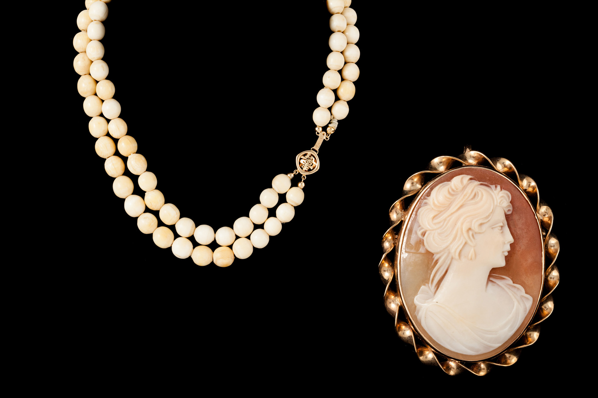 A TWO ROW BEADED NECKLACE; together with a cameo brooch,