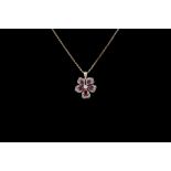 A RUBY AND DIAMOND FLOWER PENDANT AND CHAIN, with rubies of approx 1.10ct and diamonds of approx 0.