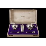 A THREE PIECE SILVER CONDIMENT SET, with applied Celtic border, two mustard spoons, Birmingham 1964,