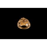 A DIAMOND SET RING, Eastern style with carved leopard,