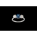 A SAPPHIRE AND DIAMOND THREE STONE RING, one oval cut sapphire of approx 1.