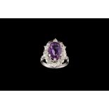 AN AMETHYST RING, set with diamonds,