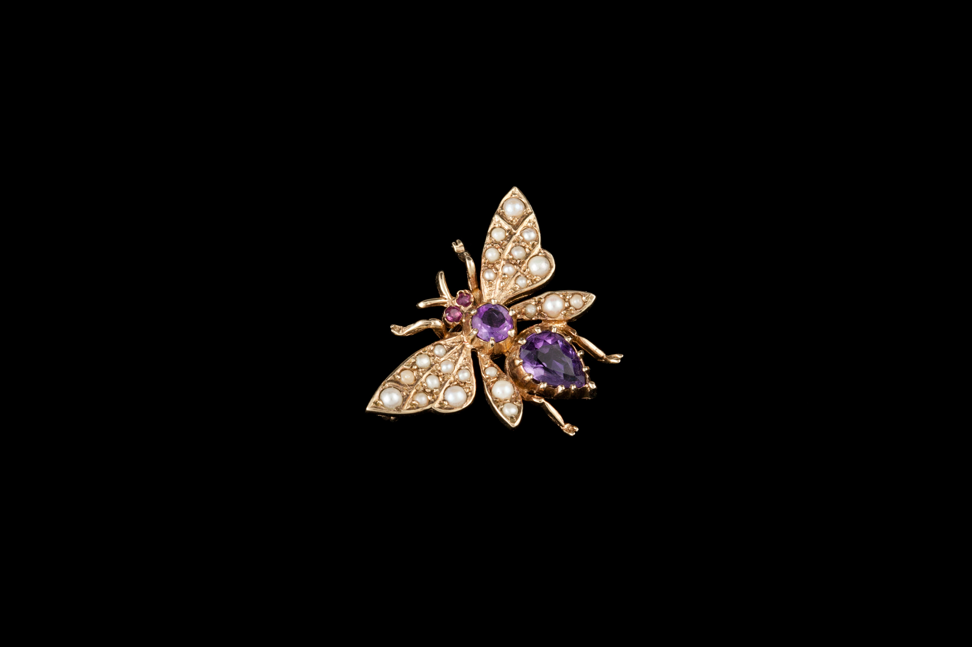 A BUTTERFLY BROOCH, set with seed pearl, amethyst and ruby,