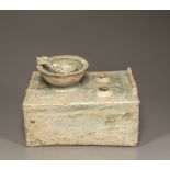 A green-glazed pottery cooking stove, bowl, and ladle