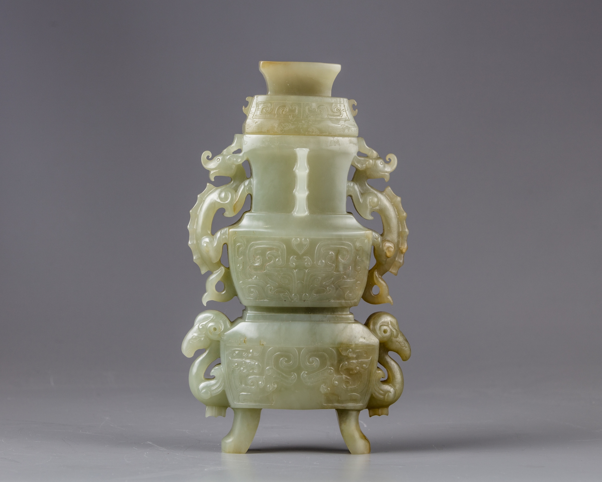 A celadon jade vase with cover