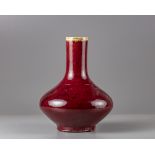 A red glazed bottle vase