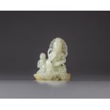 A Chinese white jade ‘Guanyin and acolyte’ carving