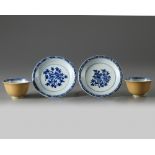 Two pairs of Chinese café-au-lait-ground blue and white cups and saucers