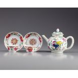 A famille teapot and two pairs of cups and saucers