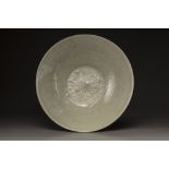 A celadon-glazed carved dish