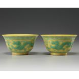 A pair of Chinese yellow-ground green-enamelled 'dragon' bowls