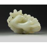 A large Chinese white jade ‘squirrel and grapes’ carving