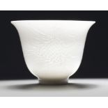 A Chinese white-glazed 'phoenix' cup