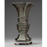 A Chinese archaistic bronze square section vase, fanggu