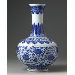 A Chinese blue and white 'scrolling lotus' bottle vase