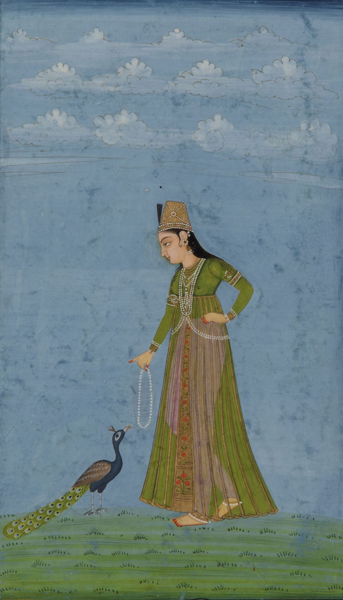 A Indian miniature depicting a lady and a peacock
