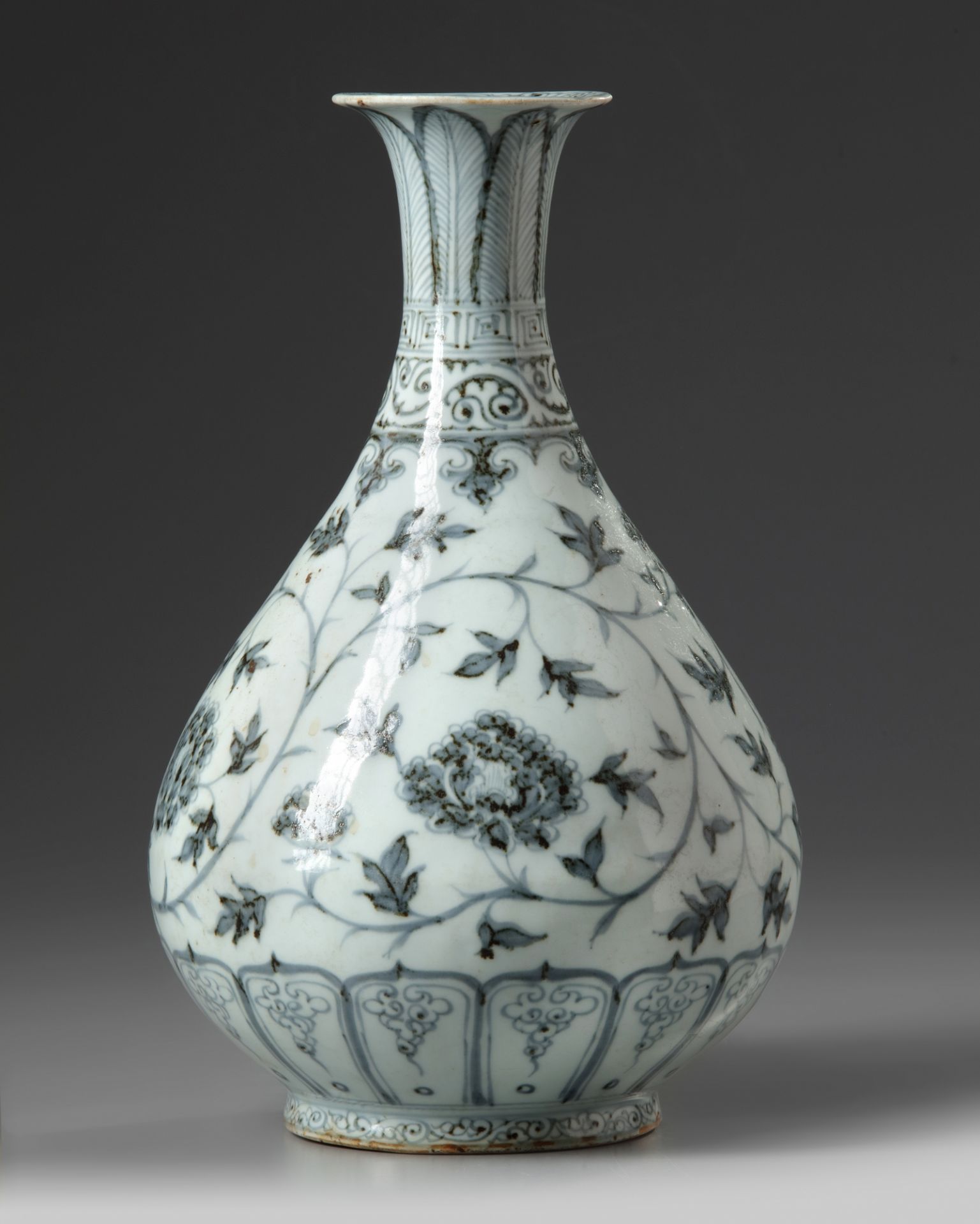 A Chinese blue and white 'scrolling peony' pear-shaped vase