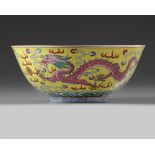 A Chinese yellow ground famille rose 'dragon and phoenix' bowl