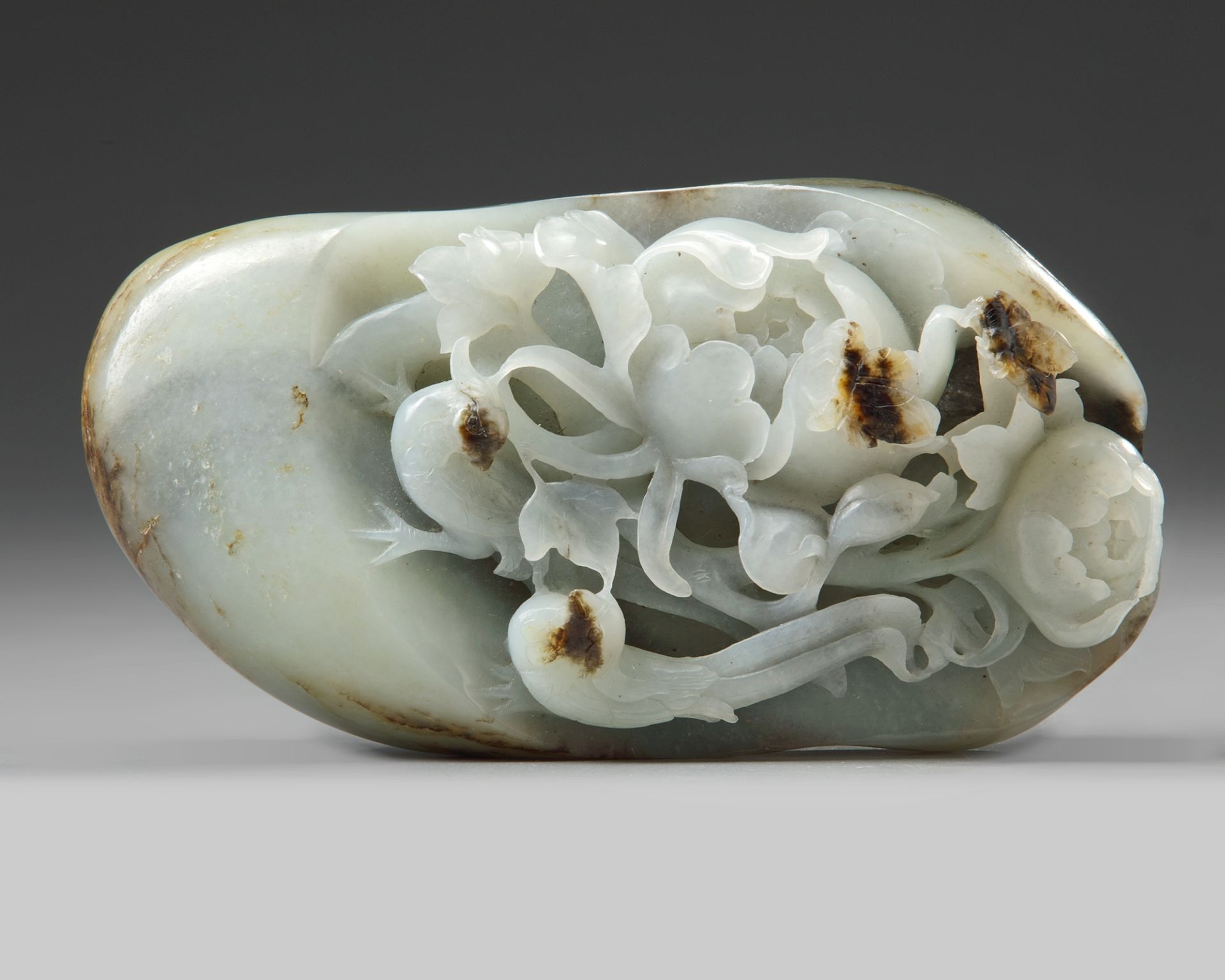 A Chinese white and russet jade 'pheasant and peony' pebble