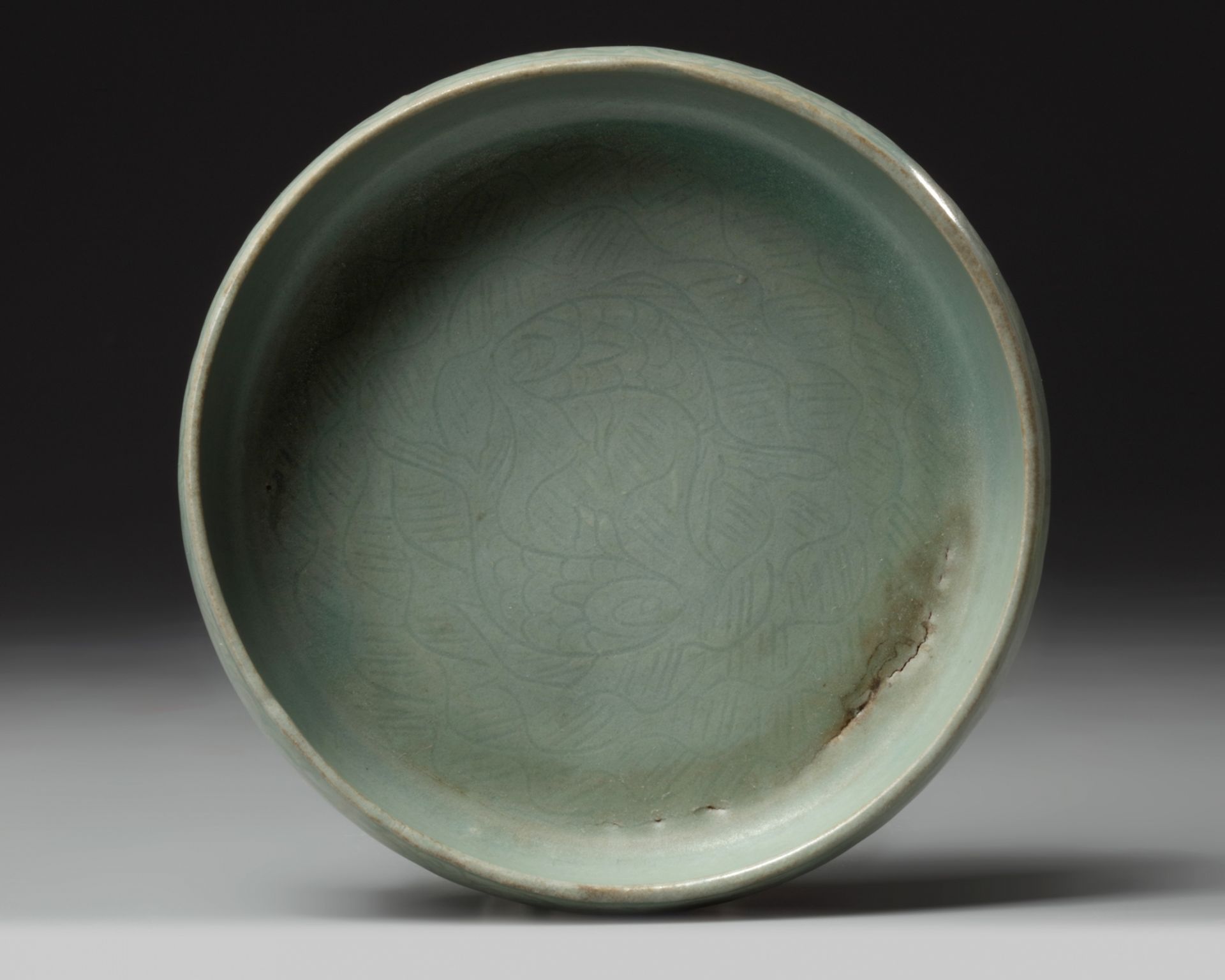 A Korean celadon-glazed 'fish and waves' washer