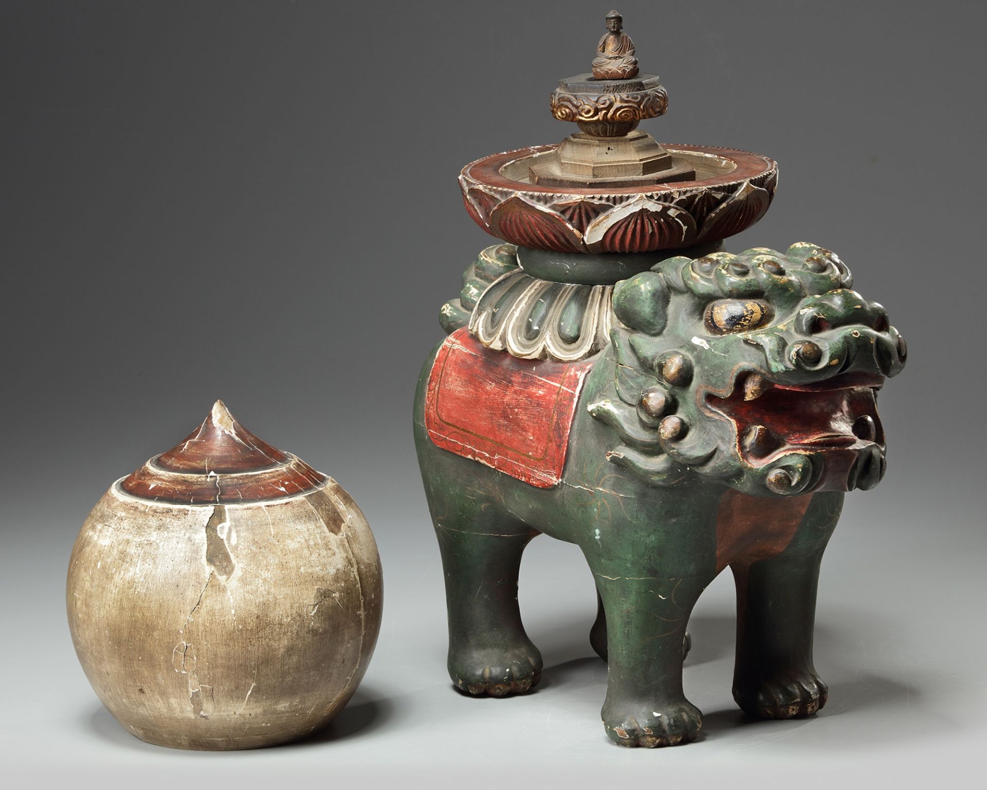 A wood carved Shishi with buddhist flame and buddha