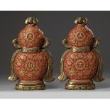 A pair of Chinese imitation lacquer double gourd wall vases