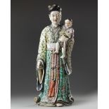 A large Chinese famille rose figure of a lady and boy