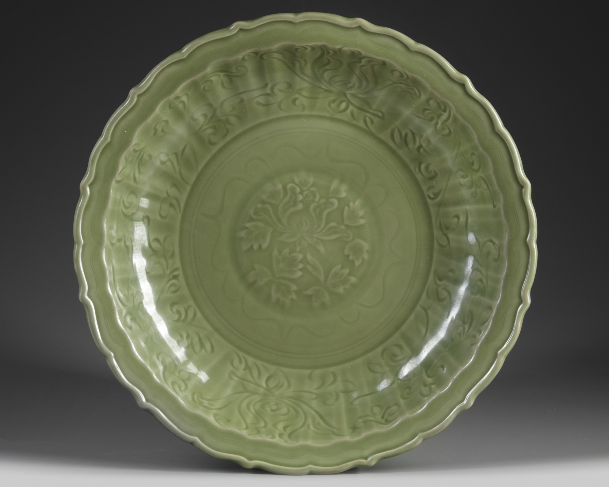 A Chinese Longquan-celadon-glazed 'lotus' barbed-rim charger